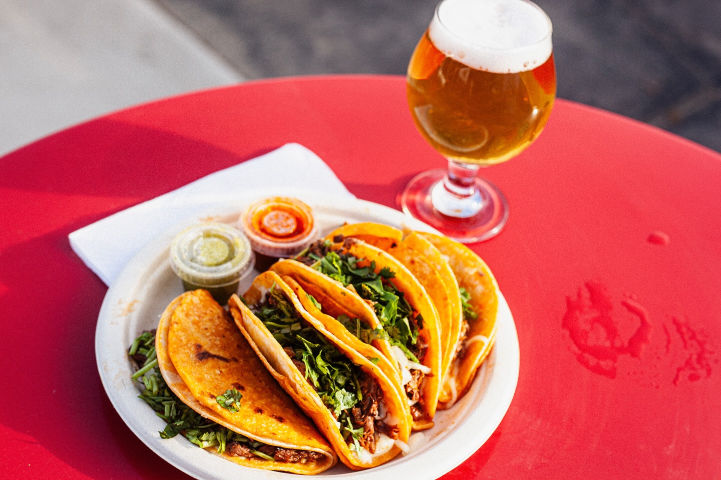 Tacos on a plate with a beer glass