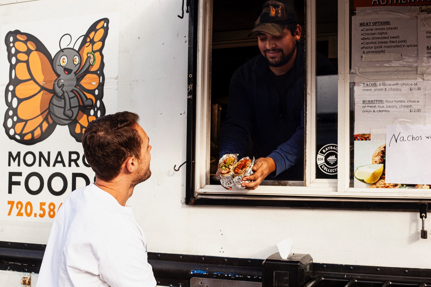 Monarca Foods team member serving food from the food truck
